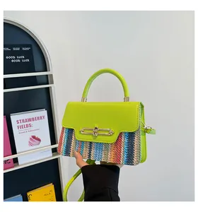 Detail of contrast color mini handbag showing neon green flap and woven stripe texture
