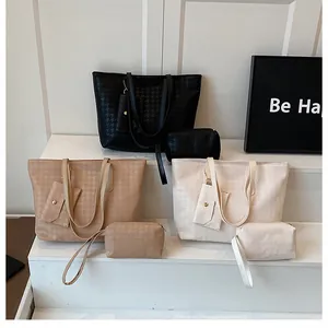 Detailed view of three-piece tote bag set with houndstooth texture in various colors
