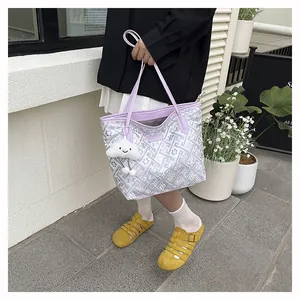 Close-up of lilac tote bag with geometric patterns and a cute cloud plush charm