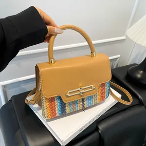Chic multi-color woven crossbody bag with camel leather top and gold twist lock closure