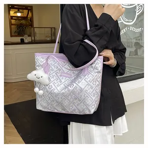 Detail of lavender tote bag featuring intricate floral embroidery and cloud pendant