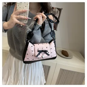 Detailed shot of pink pleated texture fabric and black bow on stylish underarm bag