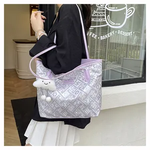 Detail of purple tote bag with geometric embroidery, long strap and cloud pendant