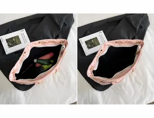 Detailed interior view of pink quilted handbag showing large capacity for essentials