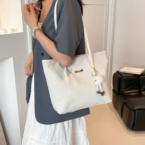 Large capacity white woven tote bag for women with gold logo and plush charm
