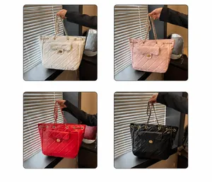Quilted tote bags in white, pink, red, and black with chain straps and gold turn-locks