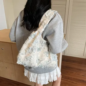Elegant white canvas tote bag with blue butterfly embroidery and fringe details