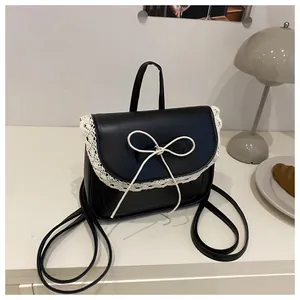 Close-up of black PU leather backpack with white lace trim and bow knot detailing