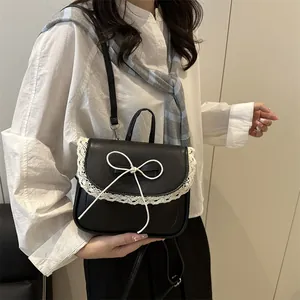 Women's black PU leather backpack with white lace trim and delicate bow detail