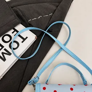 Detalle de la cómoda correa azul claro y el asa del bolso bandolera para mujer
