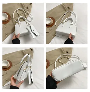 Detailed views of white crocodile pattern shell bag with small matching envelope pouch