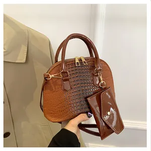 Brown crocodile embossed shell handbag with matching coin purse and golden hardware