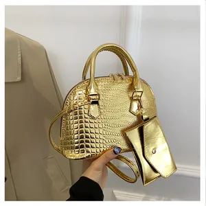 Detail of gold crocodile-pattern shell bag with matching small pendant pouch