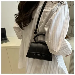 Classic black leather crossbody bag shown on model for a realistic size perspective