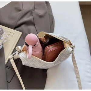 Top view showing the large capacity interior of the white dumpling bag with geometric patterns