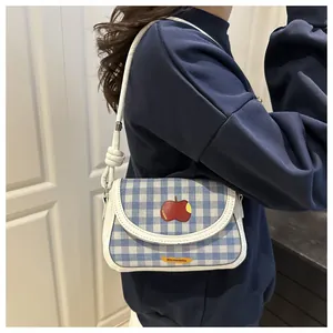 Blue gingham crossbody bag with apple embroidery and stylish knotted white shoulder strap