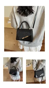 Gros plan d'un sac bandoulière noir avec rabat pailleté et détail en métal doré