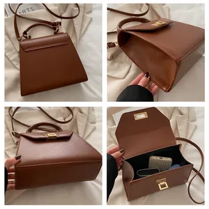 Dettaglio della borsa in pelle marrone con spazio interno e fibbia in metallo dorato