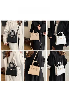 Detail view of stylish tote bag in black and beige showing shoulder and hand carry styles