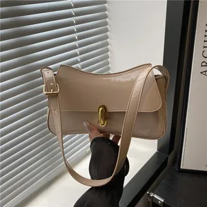 Beige patent leather shoulder bag with gold clasp and sleek rectangle saddle design