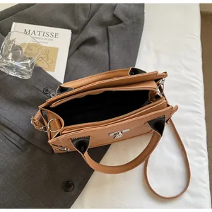 Top view of brown pebble leather handbag showing spacious interior and silver twist lock