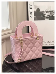 Detail view of pink quilted handbag with classic diamond stitching and gold hardware