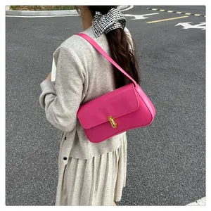 Detail of hot pink shoulder bag with gold oval twist lock closure and smooth PU leather texture