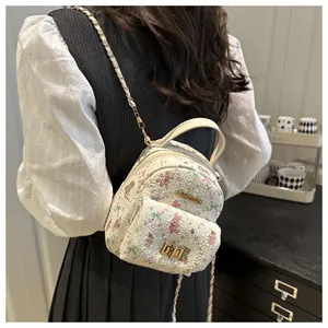 Detail of mini floral backpack with bunny print and gold Fashion buckle on textured fabric