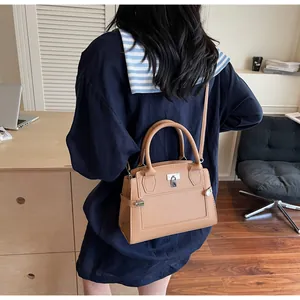 Detailed back view of a caramel crossbody bag with pebble grain texture and silver hardware