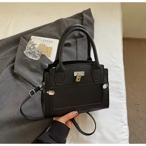 Close-up of black lychee texture handbag featuring silver hardware and a minimalist lock