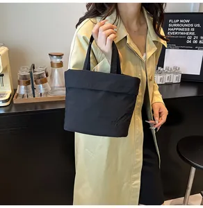 Detail of RAH TOP branded black nylon tote bag with high-quality texture and embossing