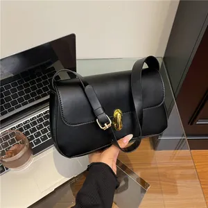 Classic black leather underarm bag with gold twist lock and wide shoulder strap