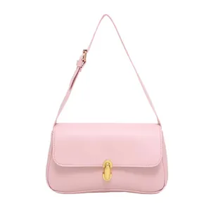 Minimalist light pink leather underarm bag with gold metal buckle and adjustable strap