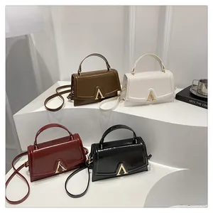 Bolsos de cuero brillante con hebillas doradas en forma de A en cuatro colores