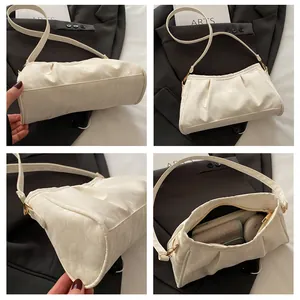 Detailed views of beige ruched cloud bag showing golden zipper and spacious interior