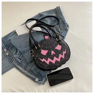 Detail of Halloween pumpkin crossbody bag with pink spider web and face embroidery