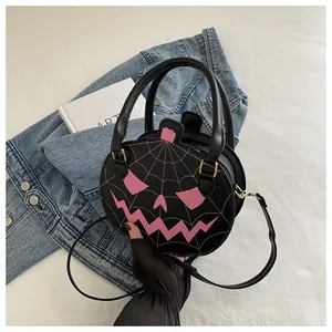 Detail of Halloween pumpkin crossbody bag with spider web embroidery and PU leather