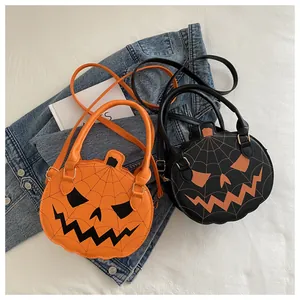 Detail of pumpkin-shaped crossbody bags featuring jack-o'-lantern faces and web stitching