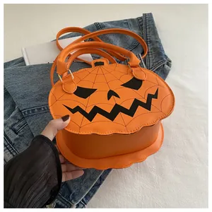 Detailed view of orange pumpkin crossbody bag with black ghost face and spider web patterns