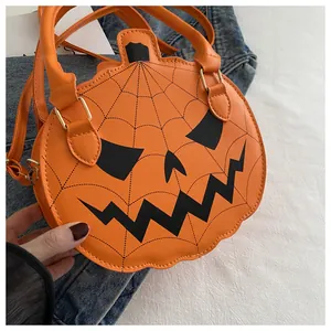 Detail of orange pumpkin bag with black spooky face and spider web stitching