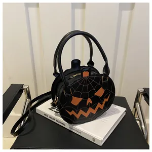 Detail view of the black PU leather pumpkin bag with orange stitched face and top zipper