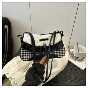 Detailed view of lace trim and heart pattern on a vintage style bow shoulder bag