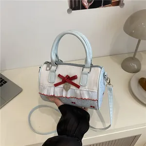 Chic blue and white bow print underarm bag with lace trim and heart pendant