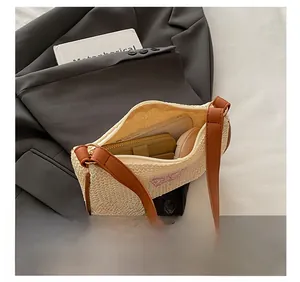 Innenkapazität der beige geflochtenen Tasche mit rosa Schmetterlingsstickerei und Leder