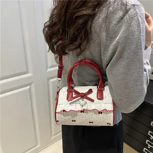 Sweet red and beige mini crossbody bag with bow charm and ruffled lace details