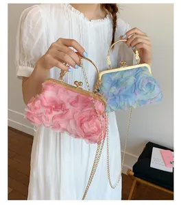 Close-up of pink and blue gradient 3D chiffon rose petals on a vintage chain bag