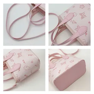 Detailed views of pink bucket bag with floral puppy prints and adjustable shoulder strap