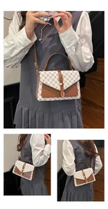 Detail view of vintage monogram crossbody bag with brown leather trim and metal buckle