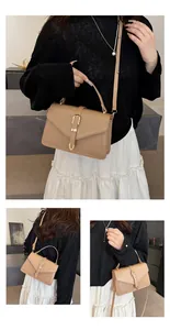 Detailed view of khaki leather square bag with golden U-buckle and versatile straps