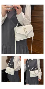 Detail showing white PU leather texture and gold buckle on stylish square crossbody bag